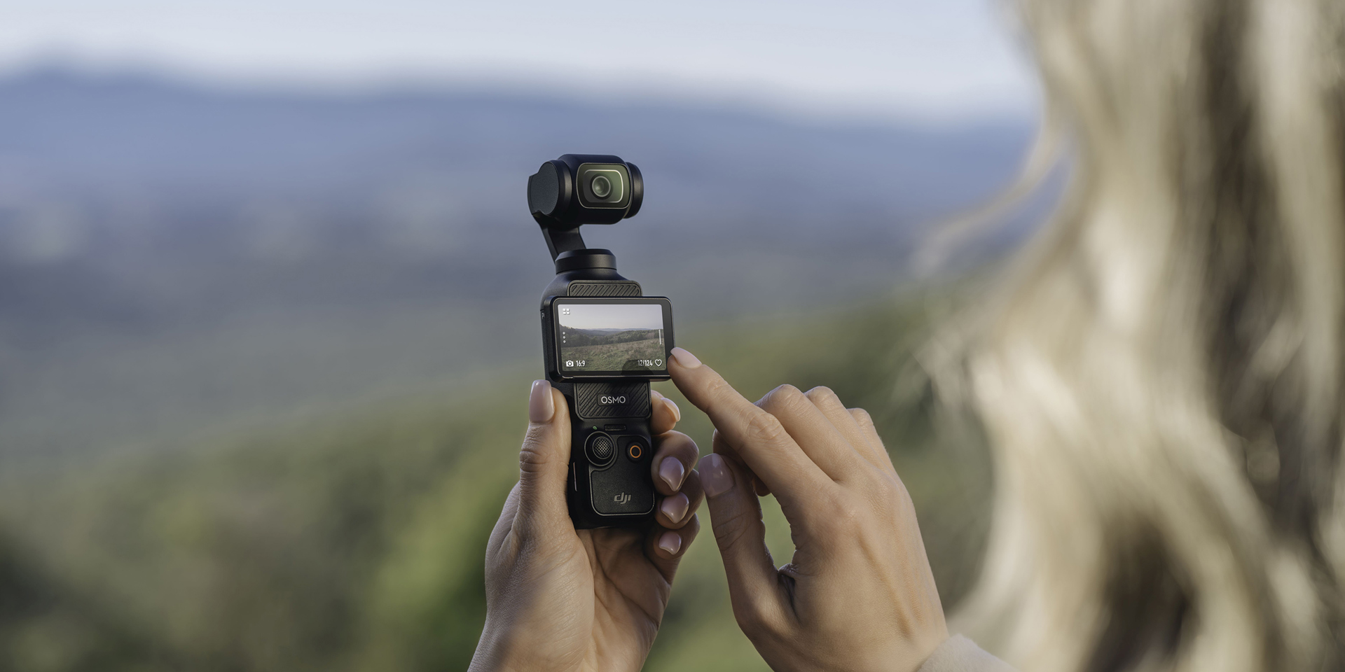 A woman using the DJI Osmo Pocket 3 camera.