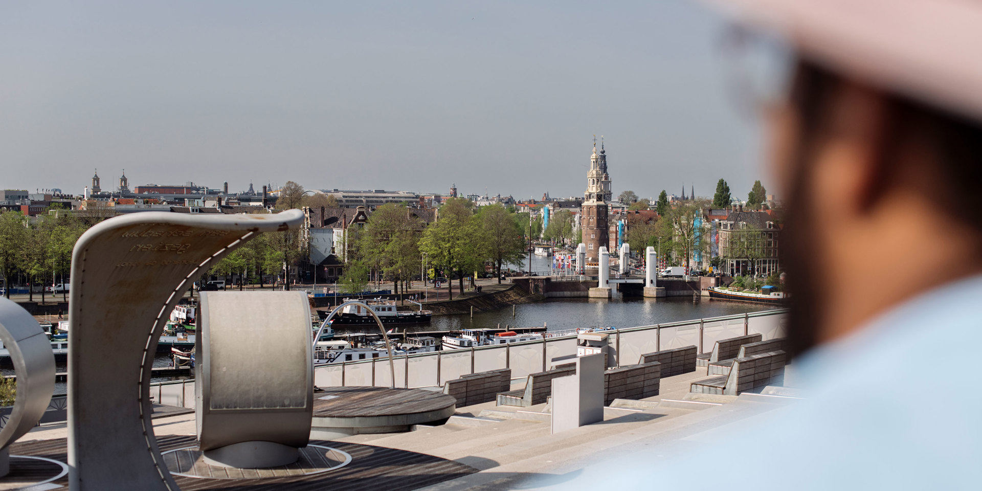 A person looking at the view from NEMO in Amsterdam.