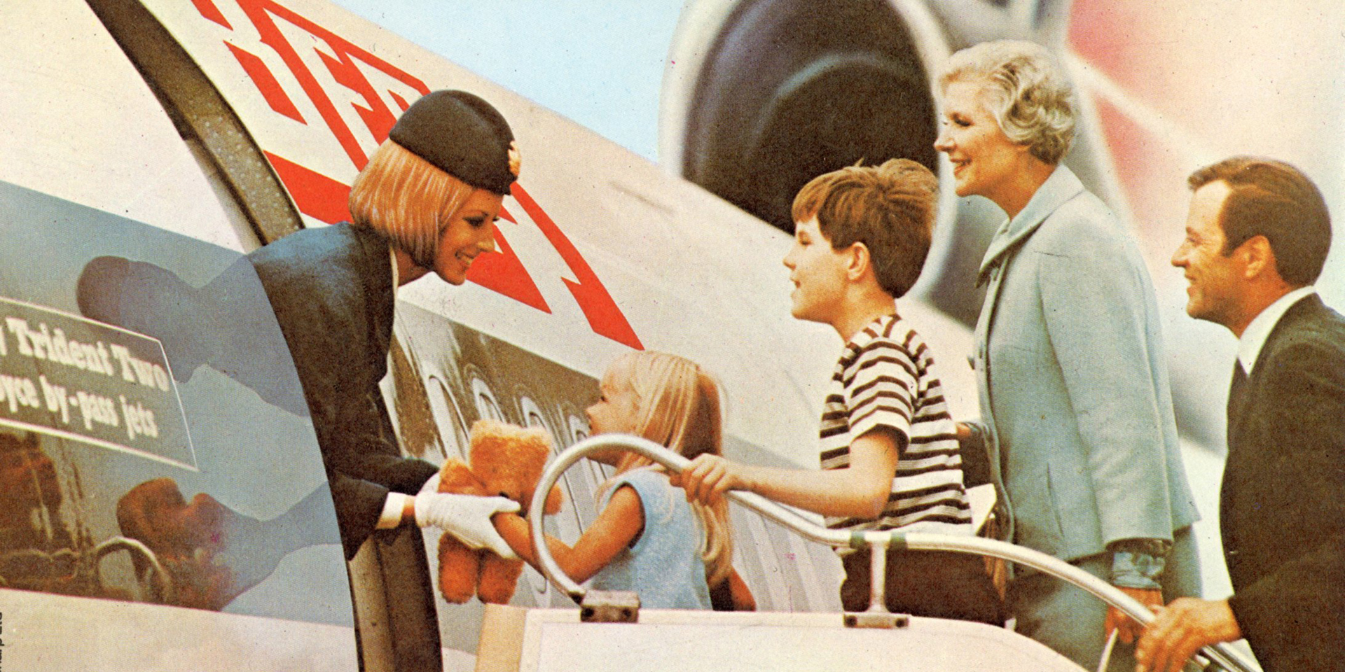 An archive shot of a family being welcomed on to a BOAC flight.