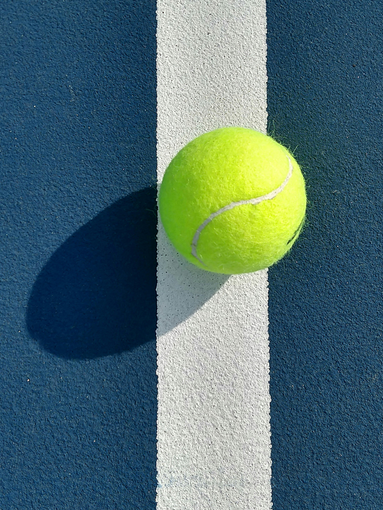 A tennis ball photographed from above.
