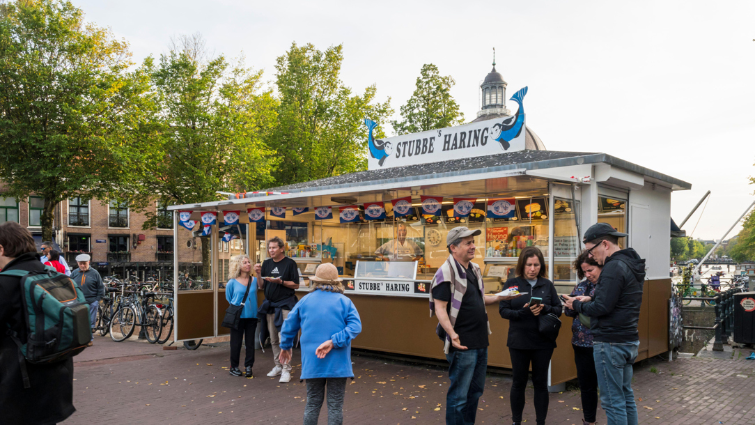 People outside a food stall in Amsterdam.