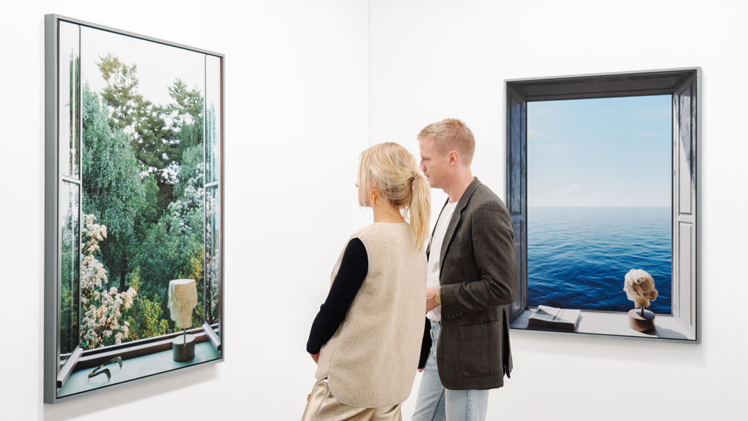 Two people looking at art work in the Unseen gallery Amsterdam.