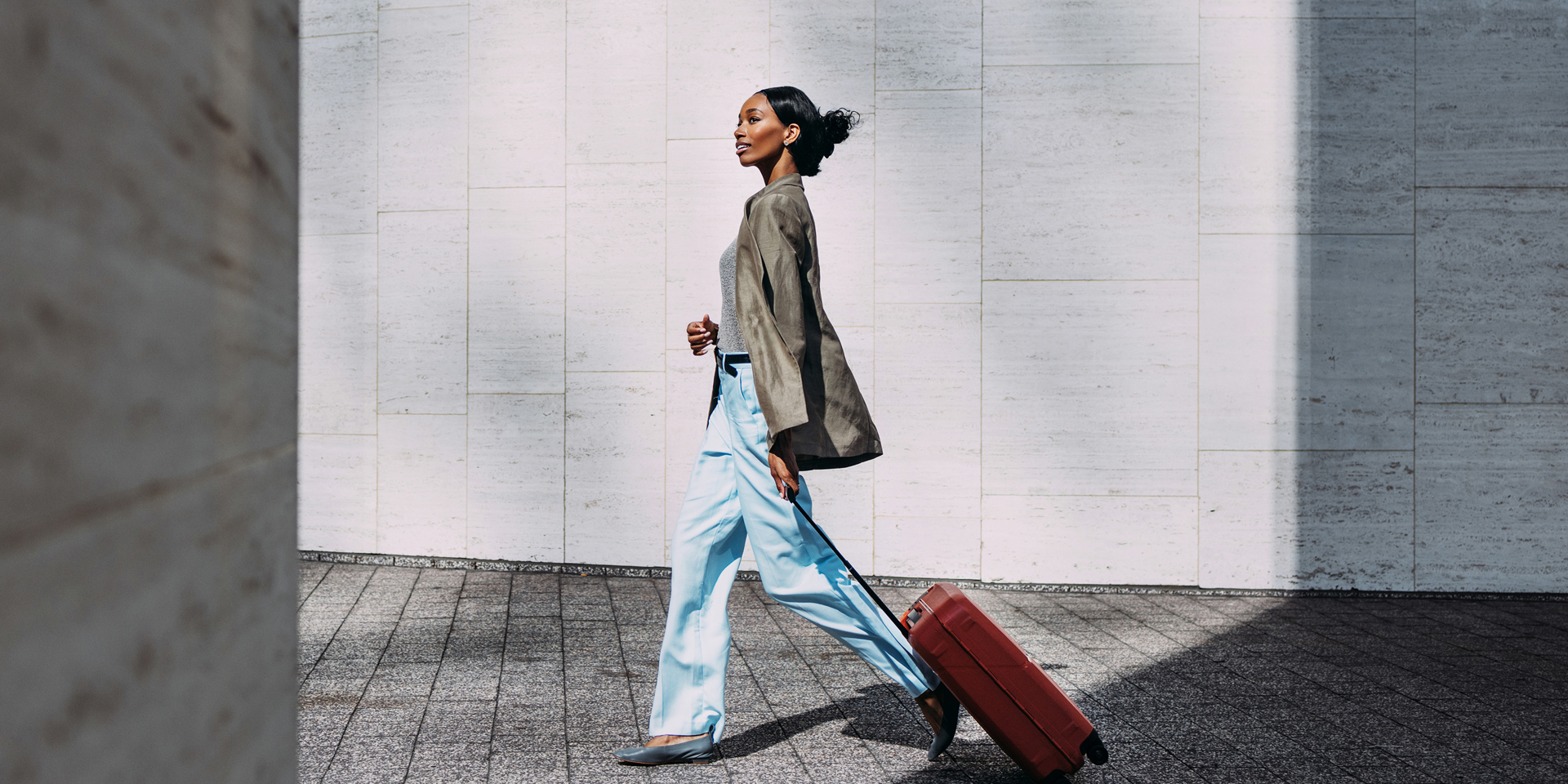 A woman walking with a suitcase