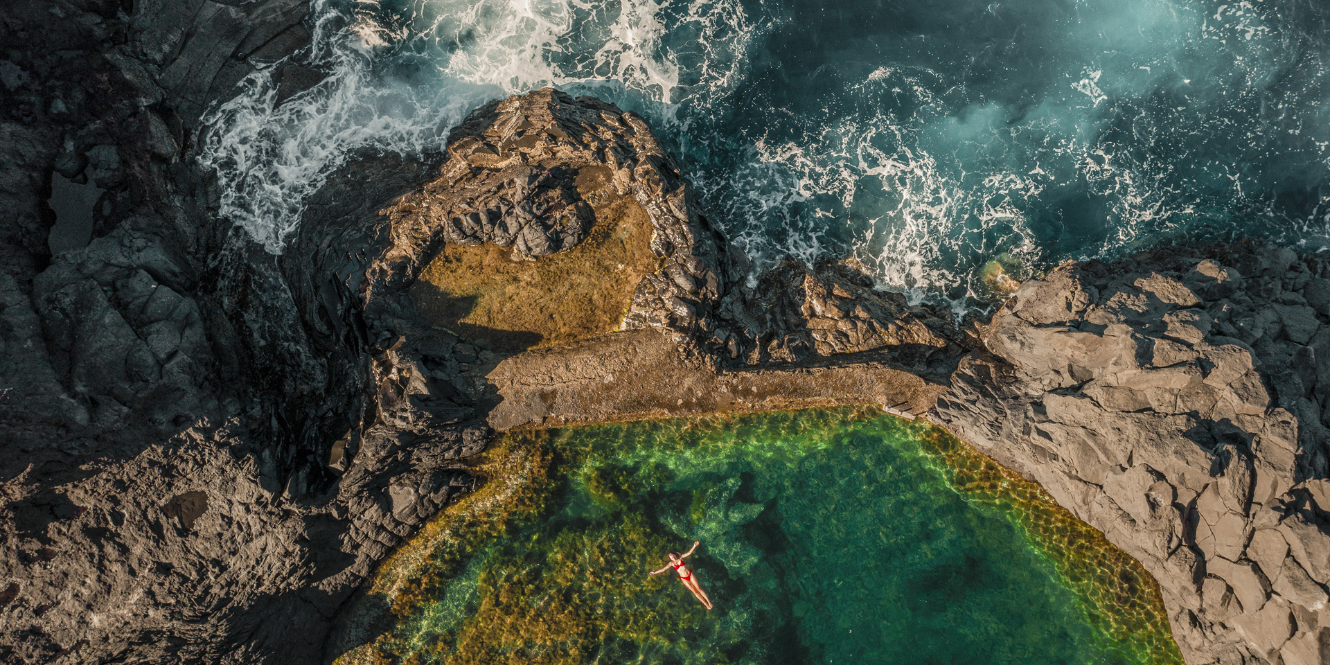 Overhead view of a rock pool next to the sea in Madeira.