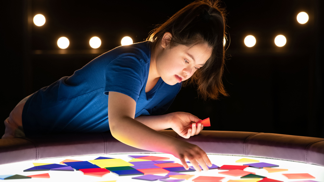 A young girl playing at the Science Museum.