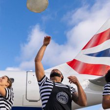 Three chefs from Pizza Express making pizza infront of a British Airways plane.