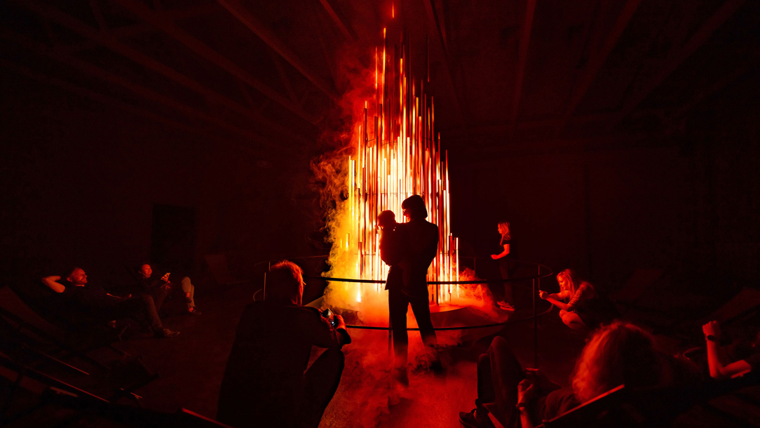 A man in silhouette against a flame.