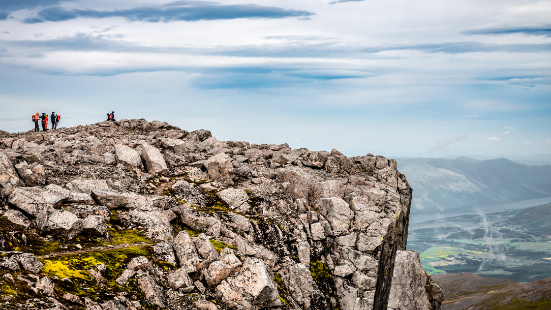 A small group of walkers on top of Ben Nevis.
