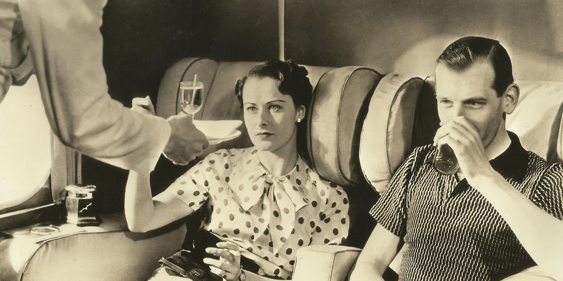 An archive photography of passengers on board an Imperial Airways plane.