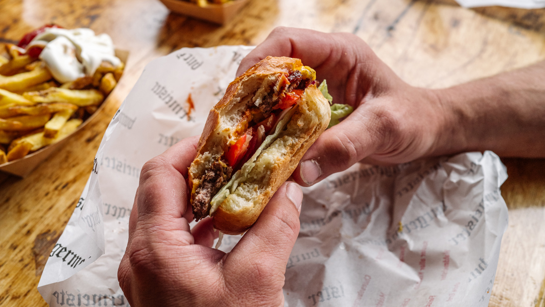 A man holding a burger.
