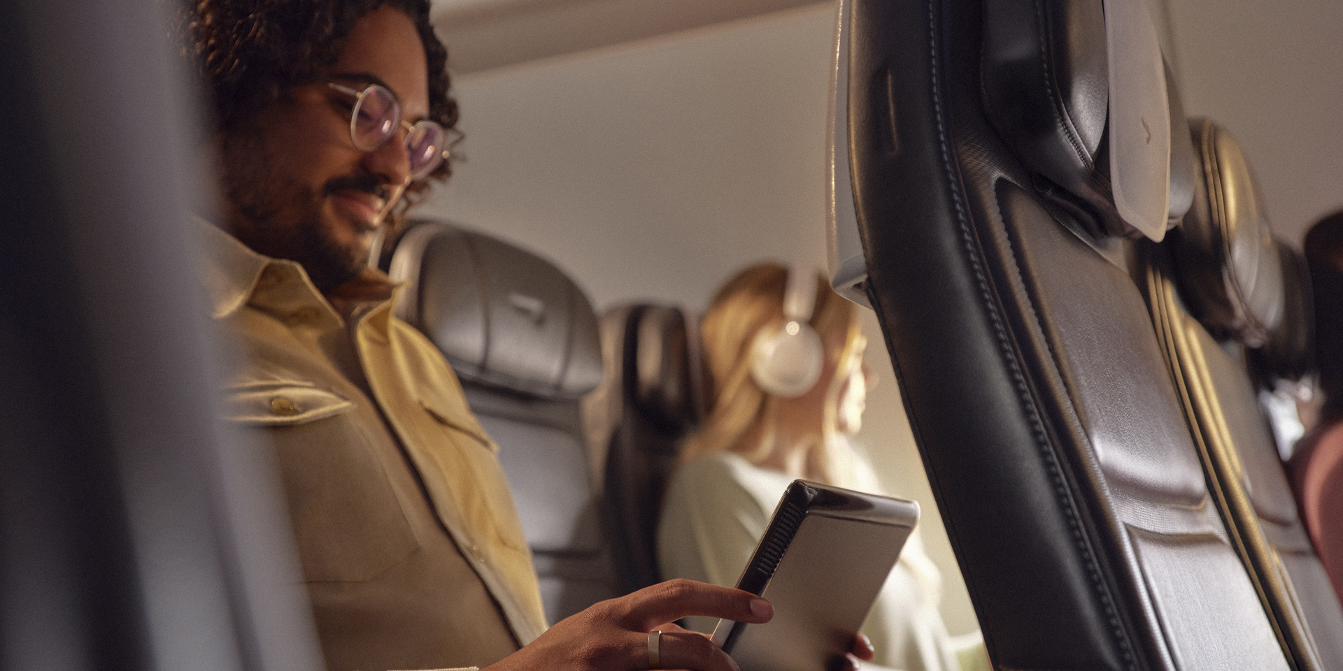 A traveller on a British Airways flight using his tablet computer.
