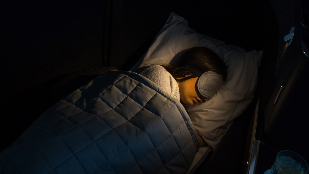 A passenger asleep on a British Airways flight.