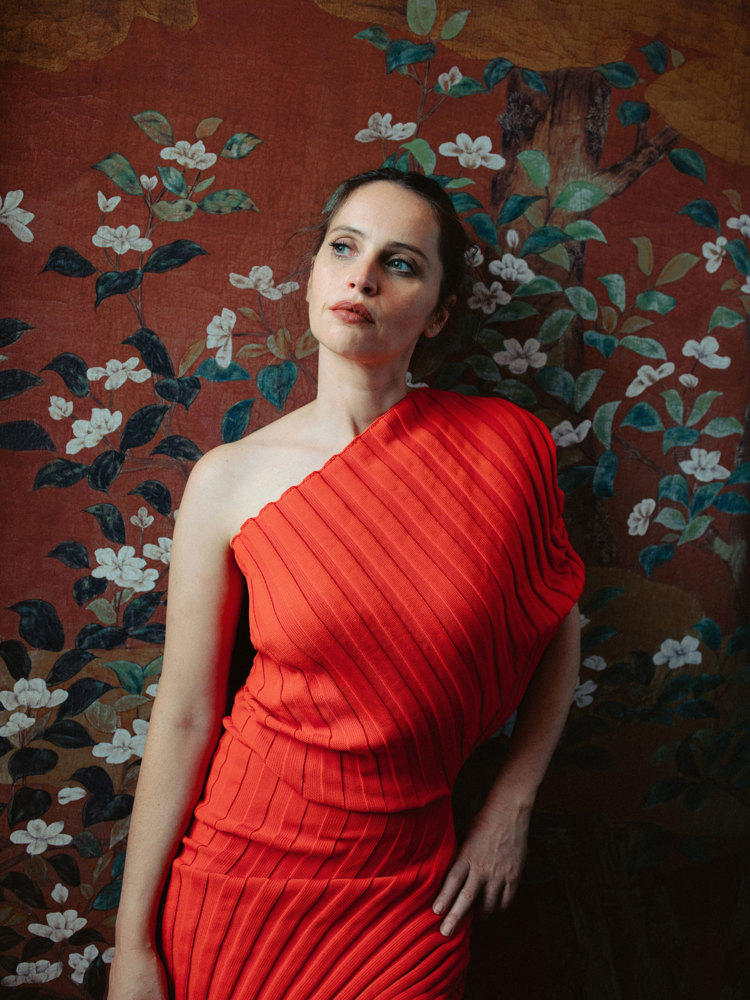 The actor Felicity Jones in a red dress.
