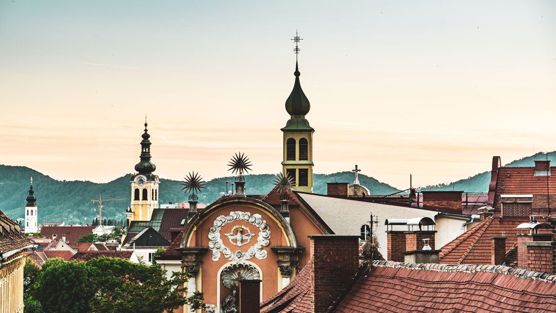 Rooftops of the old town in Graz at dusk.