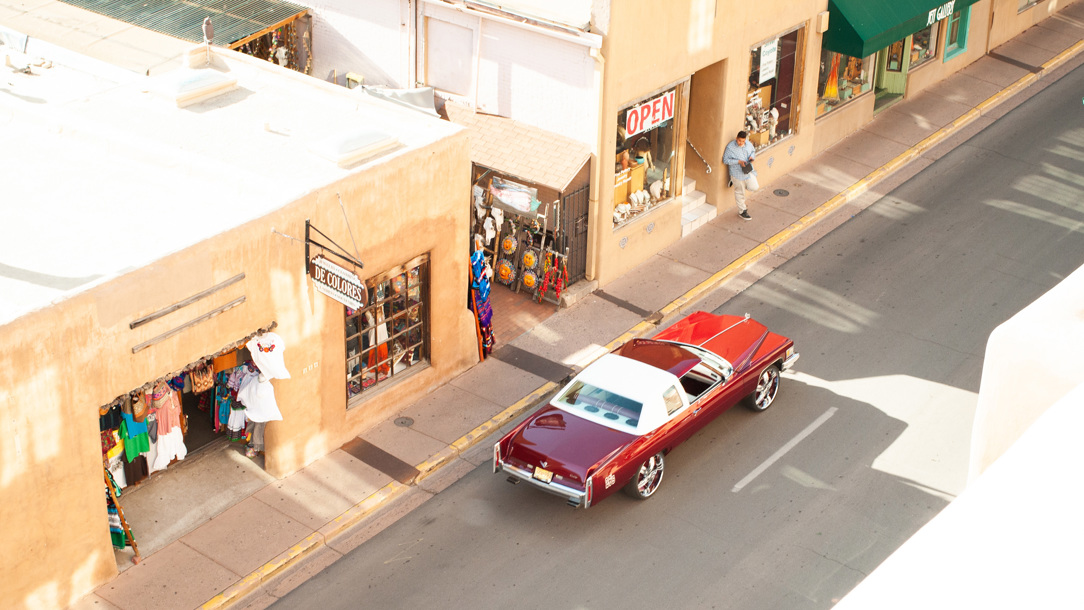 Looking down on a street with a red car in Sante Fe.