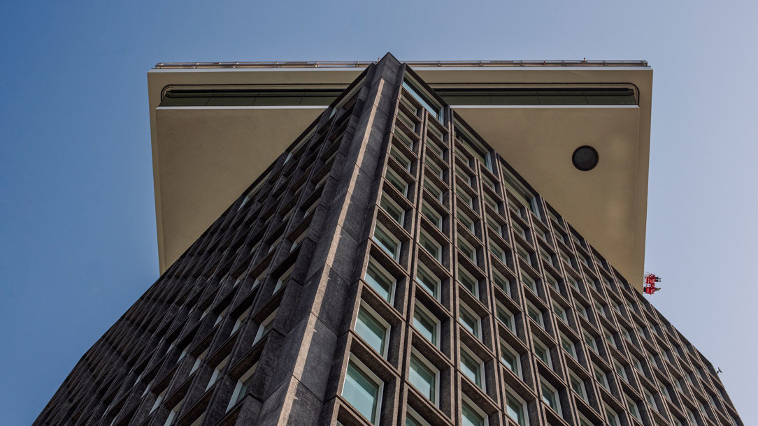 Looking up at a modern building from the ground.